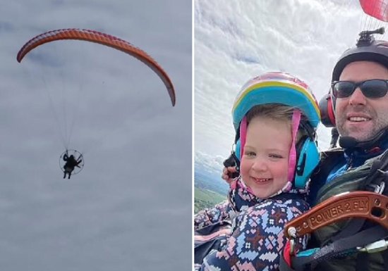 英国一名2岁<em>小女孩</em>和父亲一<em>起</em>乘滑翔伞在200米高空飞翔